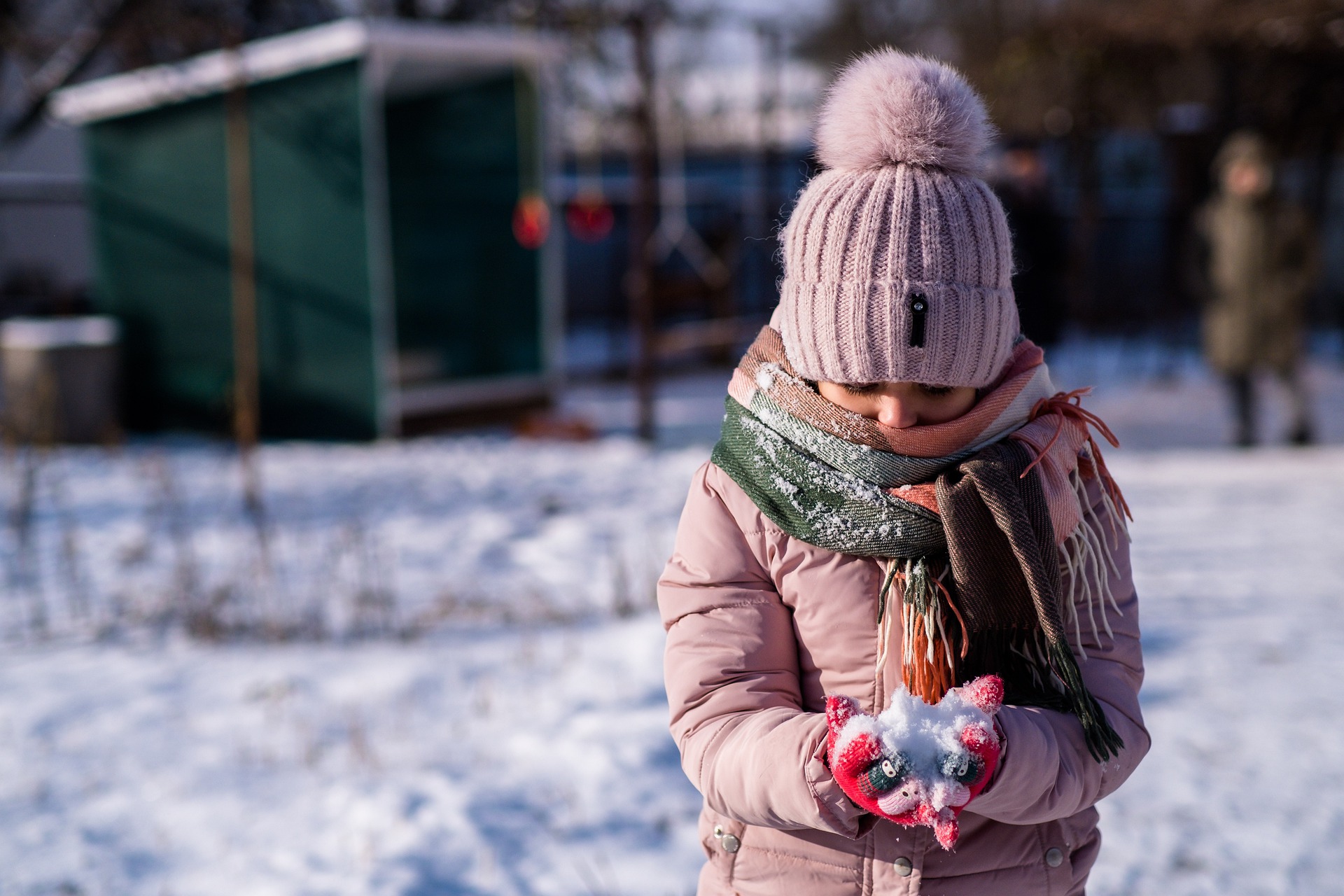 Little girl holding snow